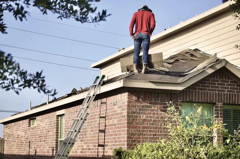 Professional roofer working on a residential roof in Wiccopee